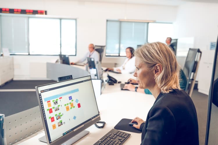 Crisis management team coordinating response efforts in a dedicated control room, ensuring quick and effective decision-making during emergencies.