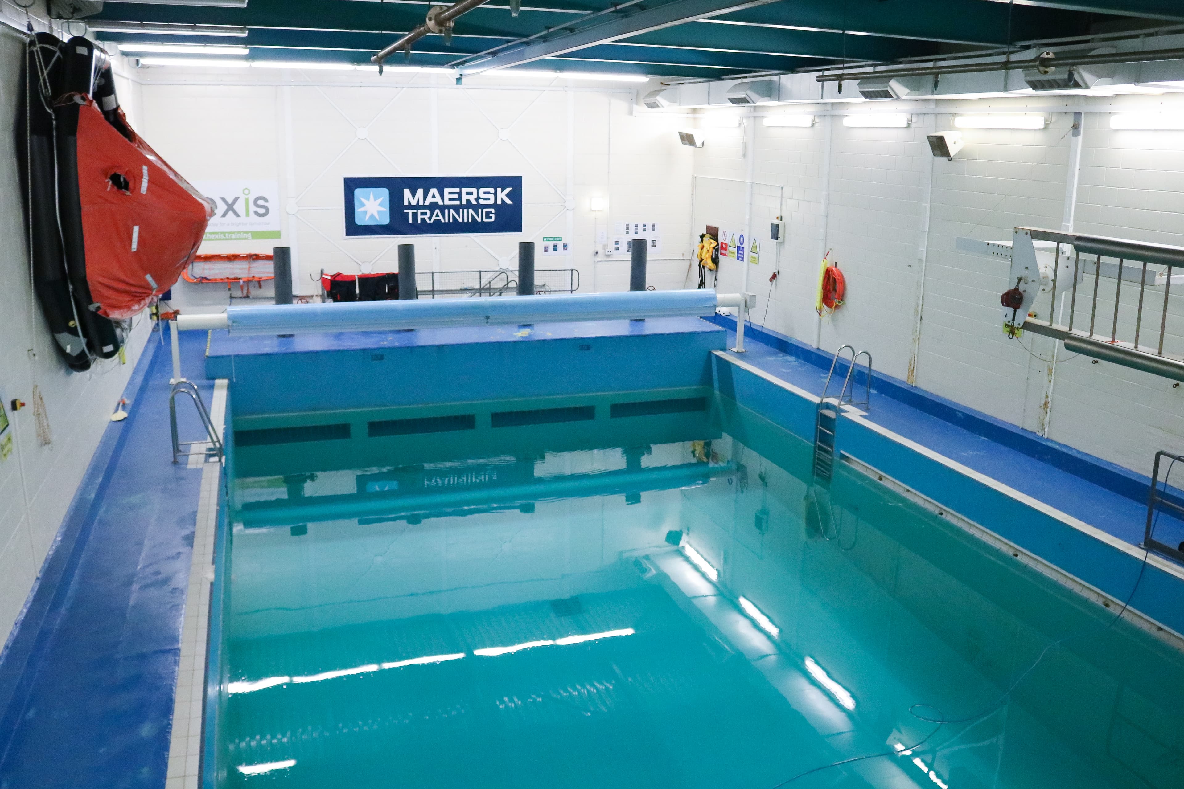 Indoor training pool at Maersk Training, designed for simulated renewables and offshore survival exercises, providing a controlled environment for safety skill development.